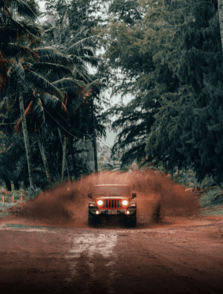 Muddy Jeep navigating challenging off-road trails