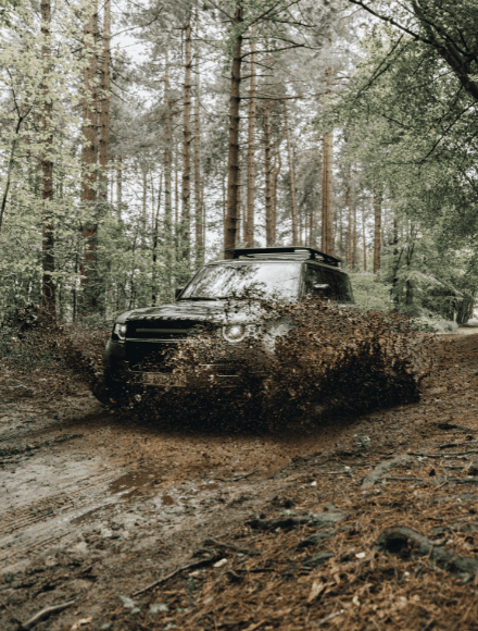 Offroad Jeep conquering rugged terrain covered in mud