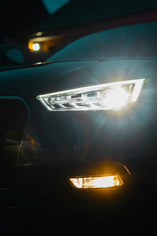 Close-up of illuminated car headlights at night