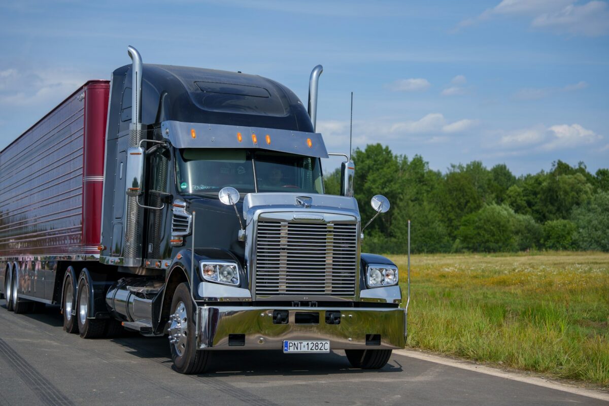Black semi truck on a rural road